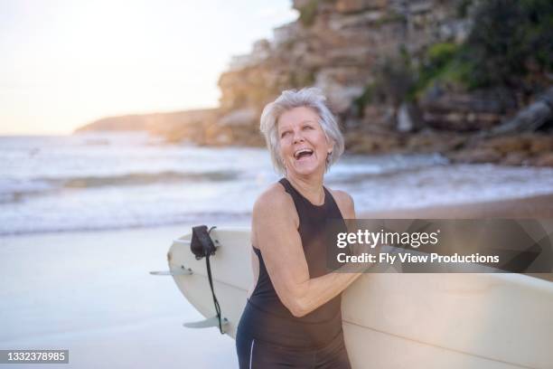 joyful retired woman enjoys surfing - energy independence stock pictures, royalty-free photos & images