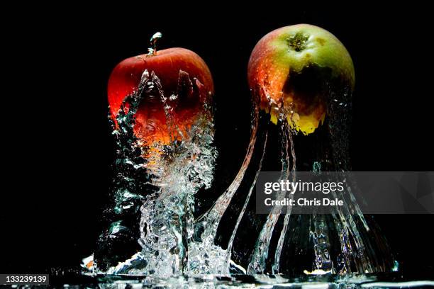 apples in water - apple water splashing stock pictures, royalty-free photos & images