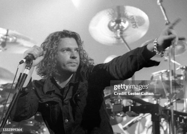 Australian musician, singer-songwriter and actor Michael Hutchence , of the Australian rock band INXS, sings on stage during the 1993 Get Out Of The...