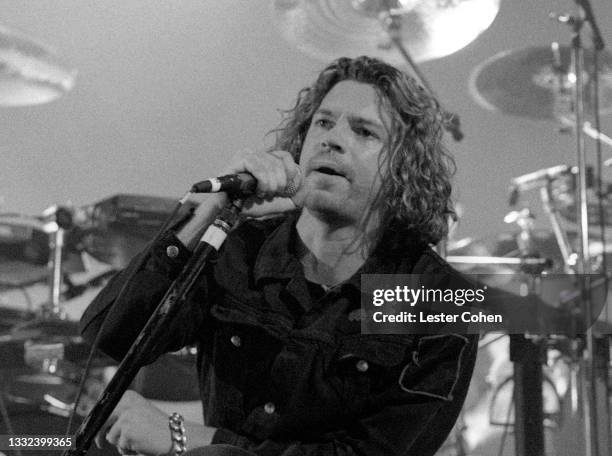 Australian musician, singer-songwriter and actor Michael Hutchence , of the Australian rock band INXS, sings on stage during the 1993 Get Out Of The...