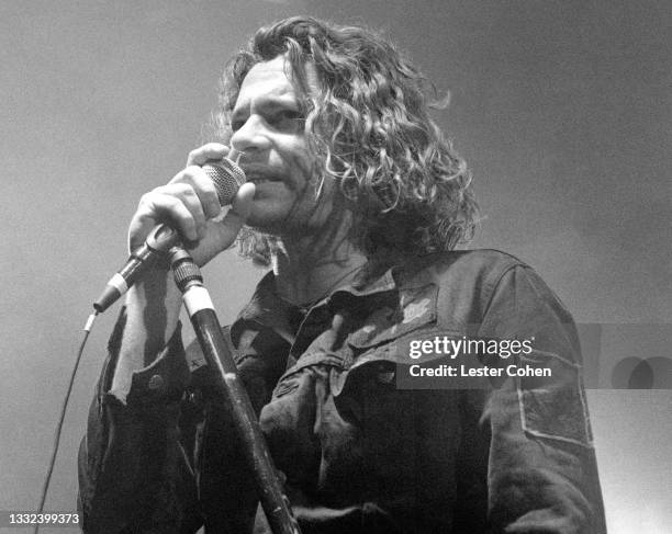 Australian musician, singer-songwriter and actor Michael Hutchence , of the Australian rock band INXS, sings on stage during the 1993 Get Out Of The...