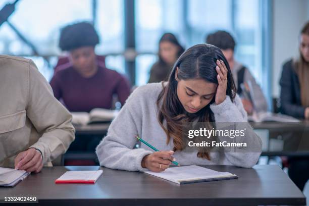 diligent student does course work in university - stressed student stock pictures, royalty-free photos & images