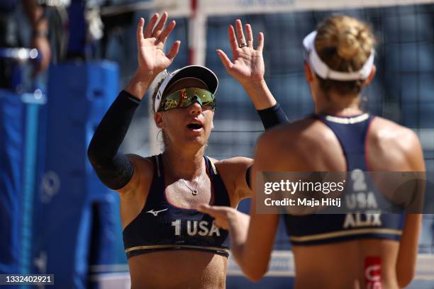 April Ross of Team United States celebrates with Alix Klineman after the play against Team Switzerland during the Women's Semifinal beach volleyball...