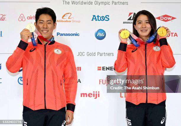 Swimming Men's 200m Butterfly silver medalist Tomoru Honda and Women's 200m & 400m Individual Medley gold medalist Yui Ohashi of Team Japan poses...