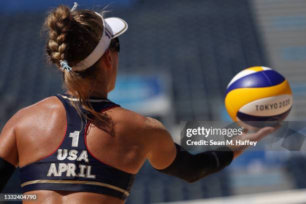 April Ross of Team United States serves against Team Switzerland during the Women's Semifinal beach volleyball on day thirteen of the Tokyo 2020...