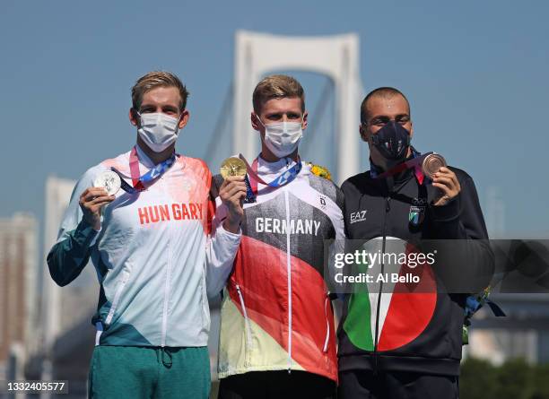 Gold medalist Florian Wellbrock of Team Germany, center, Silver medalist Kristof Rasovszky of Team Hungary, left, and Bronze medalist Gregorio...