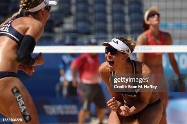 April Ross of Team United States celebrates with Alix Klineman after defeating Team Switzerland during the Women's Semifinal beach volleyball on day...