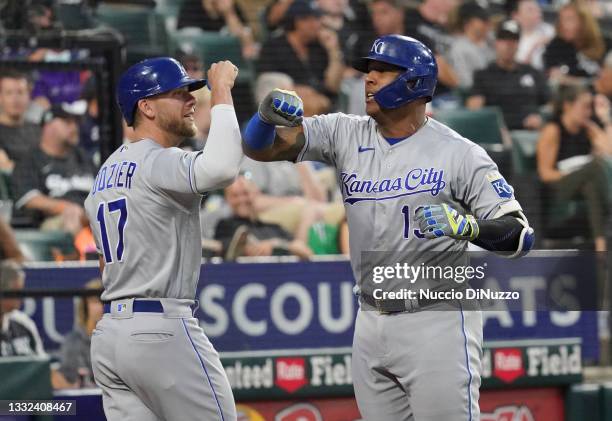 Salvador Perez of the Kansas City Royals is congratulated by Hunter Dozier following his two-run home run during the third inning of a game against...