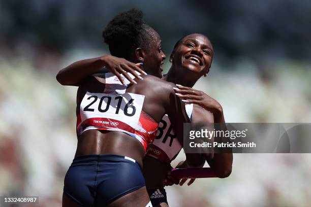Daryll Neita and Dina Asher-Smith of Team Great Britain hug after coming in first in round one of the Women's 4 x 100m Relay Heat 1 on day thirteen...