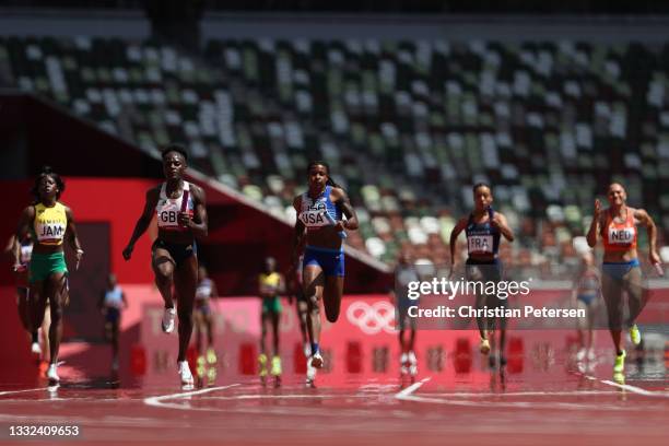 Daryll Neita of Team Great Britain leads in round one of the Women's 4 x 100m Relay heats on day thirteen of the Tokyo 2020 Olympic Games at Olympic...