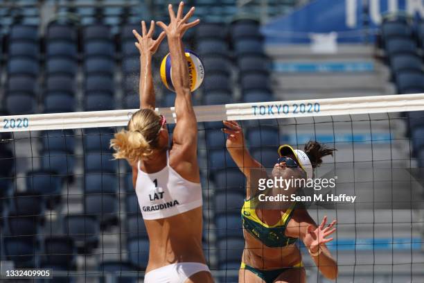 Mariafe Artacho del Solar of Team Australia hits against Tina Graudina of Team Latvia during the Women's Semifinal beach volleyball on day thirteen...