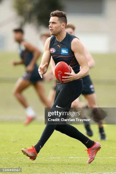 Josh Kelly of the Giants runs with the ball during a Greater Western Sydney Giants AFL training session at Holden Centre on August 05, 2021 in...