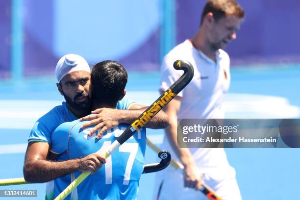 Simranjeet Singh of Team India celebrates scoring their first goal with Sumit while Martin Dominik Haner of Team Germany looks on during the Men's...