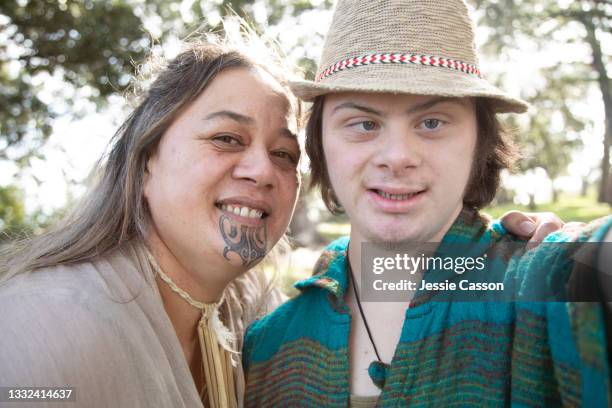 mother and son with down syndrome take selfie in the park - new zealand people stock pictures, royalty-free photos & images