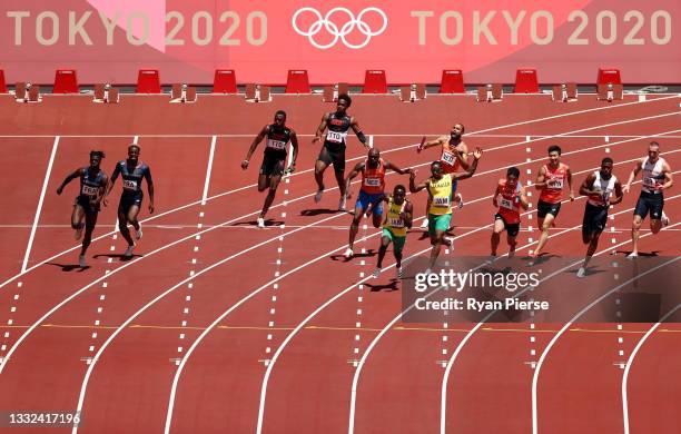 Runners pass the batons in round one of the Men's 4x100m Relay heats on day thirteen of the Tokyo 2020 Olympic Games at Olympic Stadium on August 05,...