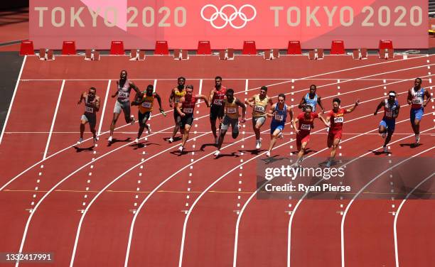 Runners pass the batons in round one of the Men's 4x100m Relay heats on day thirteen of the Tokyo 2020 Olympic Games at Olympic Stadium on August 05,...