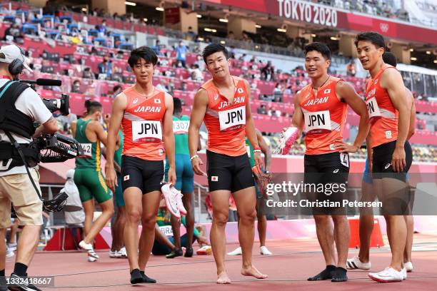 Shuhei Tada, Yoshihide Kiryu, Yuki Koike and Ryota Yamagata of Team Japan look on after competing in round one of the Men's 4 x 100m Relay heats on...