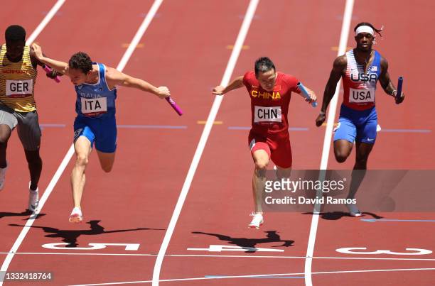 Zhiqiang Wu of Team China leads in round one of the Men's 4 x 100m Relay heats on day thirteen of the Tokyo 2020 Olympic Games at Olympic Stadium on...