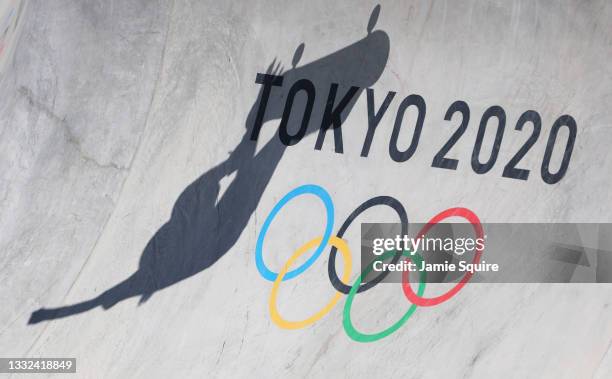 Shadow of a competitor is seen on the Olympic ring logo during the Men's Skateboarding Park Preliminary Heat on day thirteen of the Tokyo 2020...