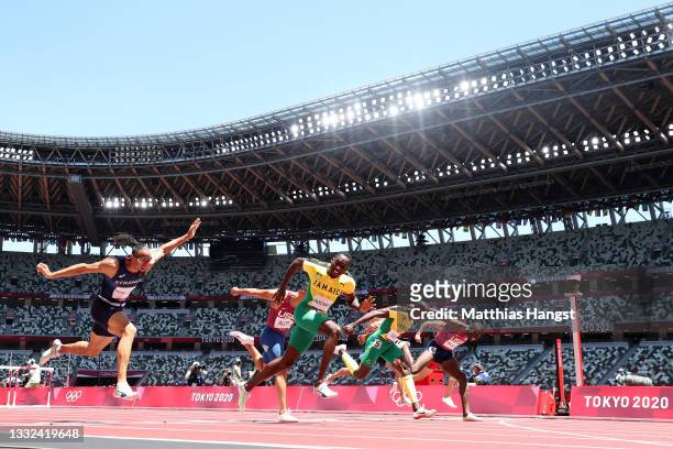 Hansle Parchment of Team Jamaica finishes first ahead of Grant Holloway of Team United States in the Men's 110m Hurdles Final on day thirteen of the...