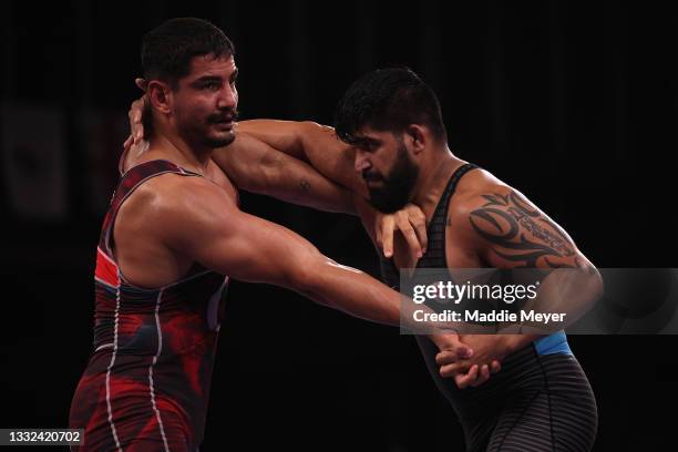 Taha Akgul of Team Turkey competes against Amarveer Dhesi of Team Canada during the Men's Freestyle 125kg 1/8 Final on day thirteen of the Tokyo 2020...