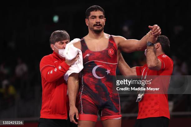 Taha Akgul of Team Turkey receives attention from his team in his match against Amarveer Dhesi of Team Canada during the Men's Freestyle 125kg 1/8...