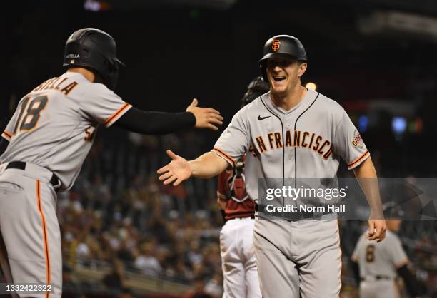 Alex Dickerson of the San Francisco Giants celebrates with Tommy La Stella after scoring on a two-run single off the bat of Donovan Solano against...