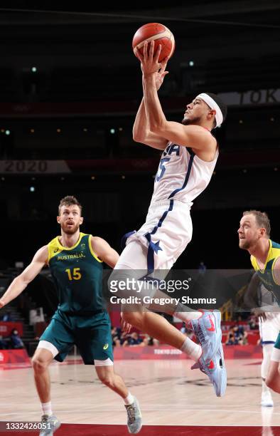 Devin Booker of Team United States goes up for a shot against Nic Kay of Team Australia during the first half of a Men's Basketball quarterfinals...