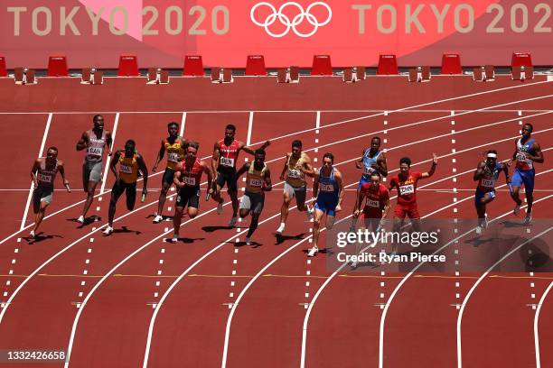 Runners pass the batons in round one of the Men's 4x100m Relay heats on day thirteen of the Tokyo 2020 Olympic Games at Olympic Stadium on August 05,...