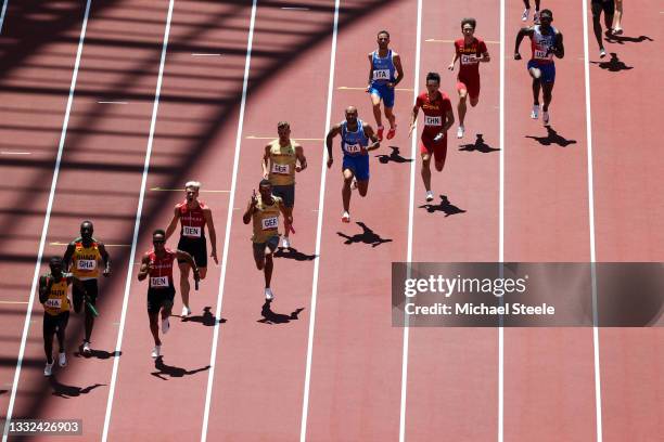 Lamont Marcell Jacobs of Team Italy, center, competes in round one of the Men's 4 x 100m Relay heats on day thirteen of the Tokyo 2020 Olympic Games...