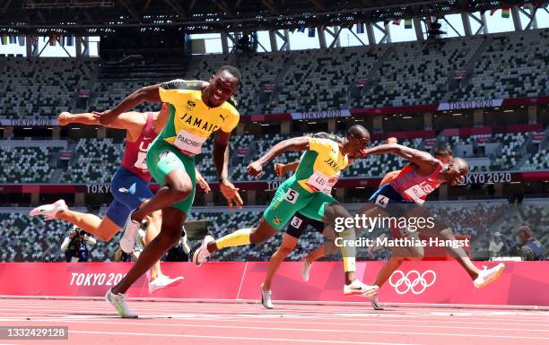 Hansle Parchment of Team Jamaica finishes first ahead of Grant Holloway of Team United States and Ronald Levy of Team Jamaica to win the gold medal...