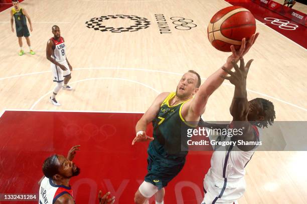 Joe Ingles of Team Australia drives to the basket against Jrue Holiday of Team United States during the first half of a Men's Basketball...