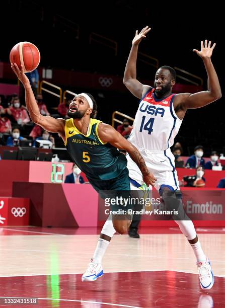 Patty Mills of Australia is fouled by Draymond Green of the USA during the Basketball semi final match between Australia and the USA on day thirteen...
