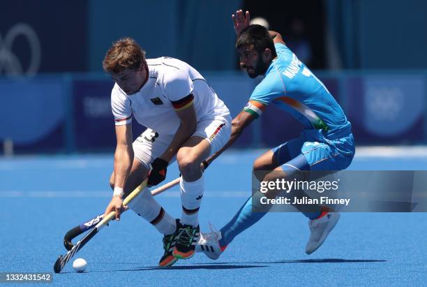Jan Christopher Ruhr of Team Germany in action with Manpreet Singh of Team India during the Men's Bronze medal match between Germany and India on day...