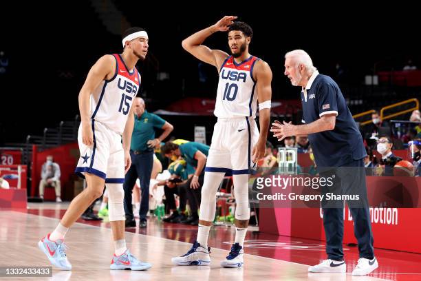 Team United States Head Coach Gregg Popovich talks strategy with Devin Booker and Jayson Tatum during the first half of a Men's Basketball...