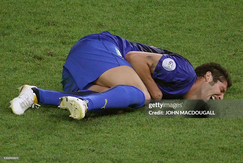 Italian defender Marco Materazzi lies on