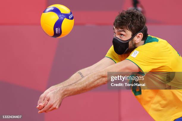 Lucas Saatkamp of Team Brazil returns the ball while wearing a face mask against Team ROC during the Men's Semifinals volleyball on day thirteen of...