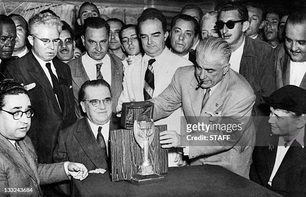 Representatives of the Italian football federation present the Jules Rimet Cup to their Brazilian counterparts 22 June 1950 in Rio de Janeiro, two...