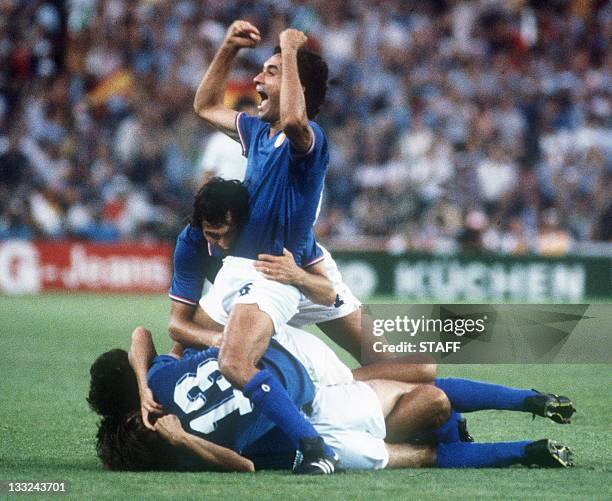 Italians defenders Antonio Cabrini and Claudio Gentile celebrate on top of their teammates after Italy defeated West Germany 3-1 in the World Cup...