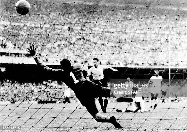 Uruguayan forward Juan Alberto Schiaffino kicks the ball past Brazilian goalkeeper Moacyr Barbosa to tie the score at 1 during the World Cup final...