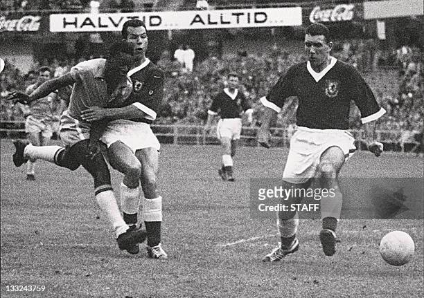 Year-old Brazilian forward Pele kicks the ball past two Welsh defenders during the World Cup quarterfinal soccer match between Brazil and Wales 19...