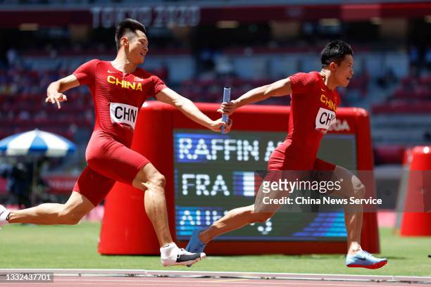 Xie Zhenye and Su Bingtian of Team China compete in the Men's 4 x 100m Relay Round 1 - Heat 2 on day thirteen of the Tokyo 2020 Olympic Games at...