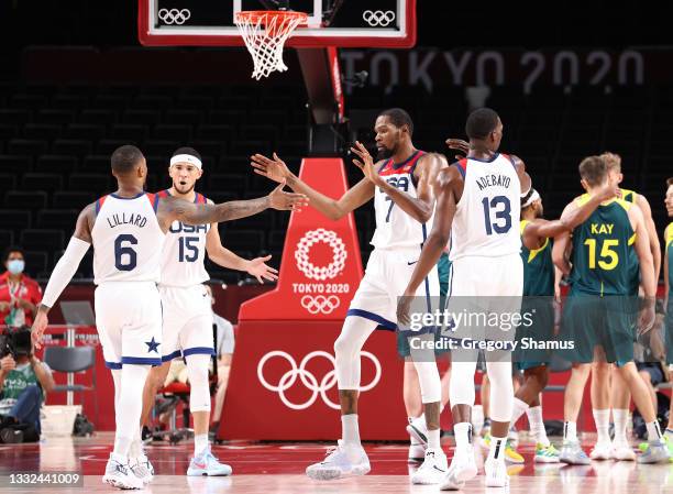Kevin Durant of Team United States high-fives teammate Damian Lillard during the first half of a Men's Basketball quarterfinals game on day thirteen...