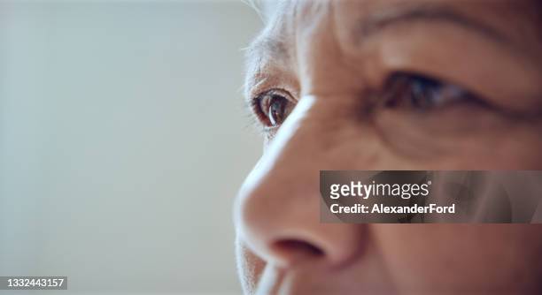 closeup shot of a senior woman's face - retina stock pictures, royalty-free photos & images
