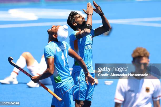 Sumit of Team India reacts with team mate Mandeep Singh after winning the Men's Bronze medal match between Germany and India on day thirteen of the...
