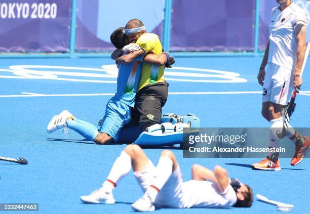 Goalie Sreejesh Parattu Raveendran of Team India celebrates after winning while Lukas Windfeder of Team Germany reacts following the Men's Bronze...