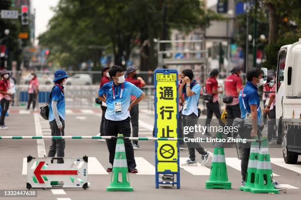 Games workforce staff prepare for the start of the Men's 20km Race Walk on day thirteen of the Tokyo 2020 Olympic Games at Sapporo Odori Park on...