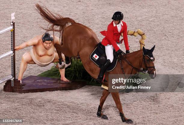 Daisuke Fukushima of Team Japan riding Chanyon clears the sumo wrestler jump during the Jumping Individual Final on day twelve of the Tokyo 2020...