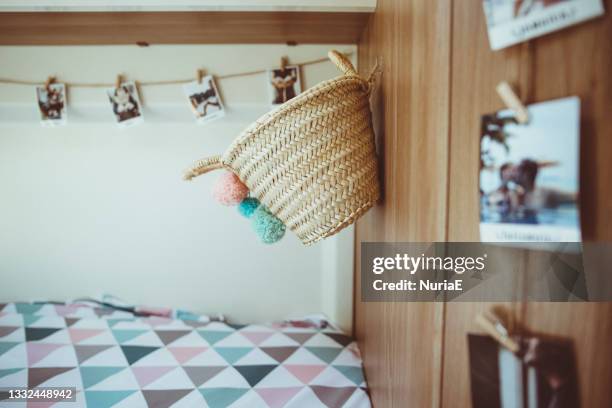 photographs and a basket hanging on a wall in a camper van - wall e stock pictures, royalty-free photos & images