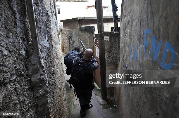 Policemen search the Morro do Alemao shantytown on November 28, 2010 in Rio de Janeiro, Brazil. After days of preparation, Brazilian security forces...